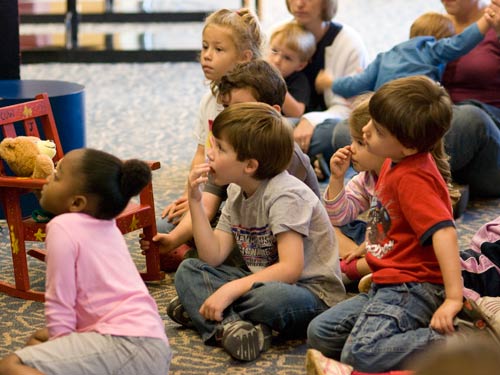 Story Time Image of children listening to a librarian at story time